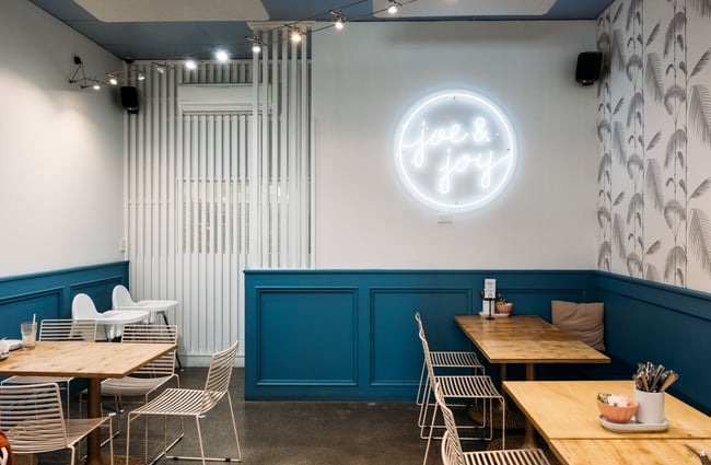 A blue and white decorated lounge area in a cafe.