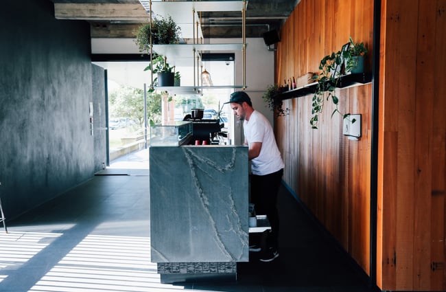 Barista cleaning up behind the counter.