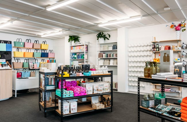 Products on display on shelves and tables in the store at Journey & Co.