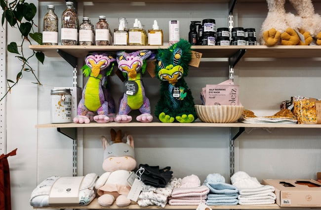 Toys and other products on a shelf display at Journey & Co.