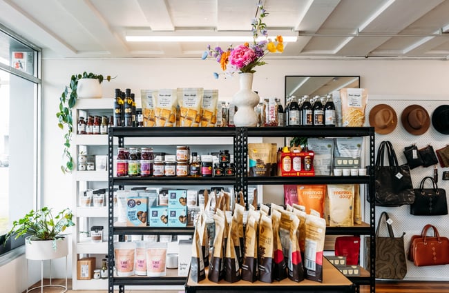 Food products on a large display shelf at Journey & Co.
