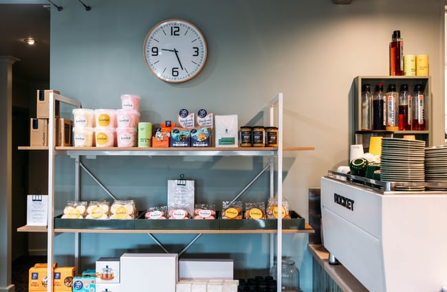 Products on a shelf beside the coffee machine at Kōwhai Eatery.