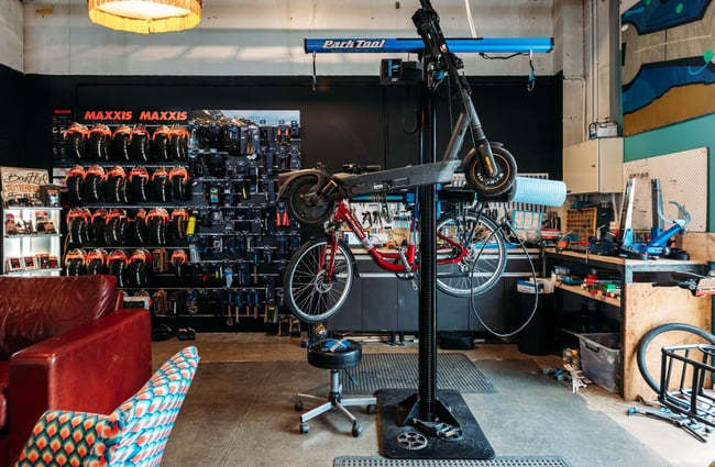 A bike being repaired inside a bike shop.