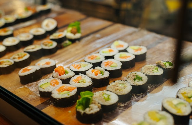 A close up of sushi on display.