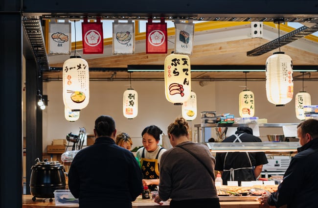 Customers ordering at a restaurant counter.
