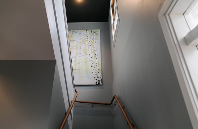 Artwork on the wall by staircase.