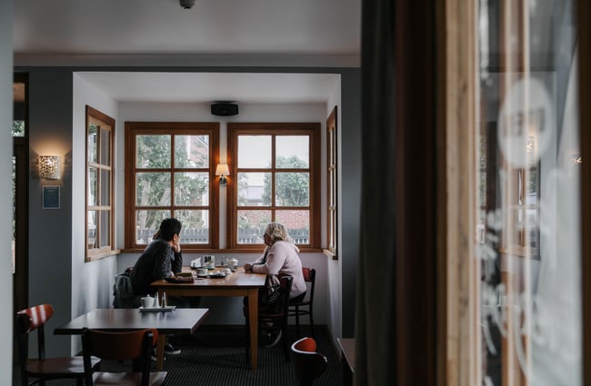 Couple sat at a table at Kaikōura Boutique Hotel.