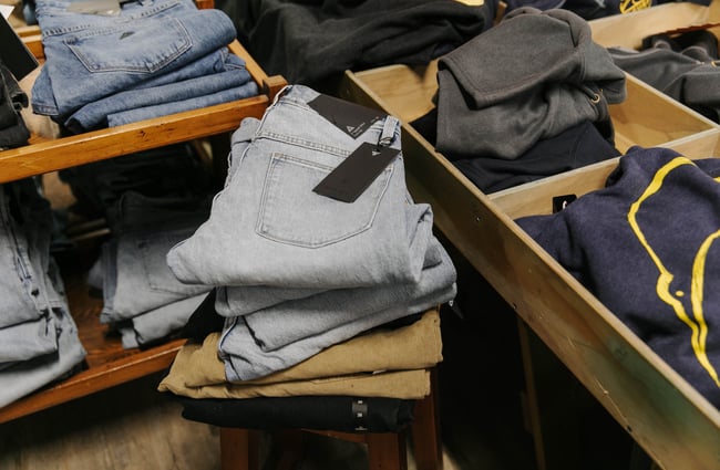 Folded pile of jeans for sale at Kaikōura Surf Company.