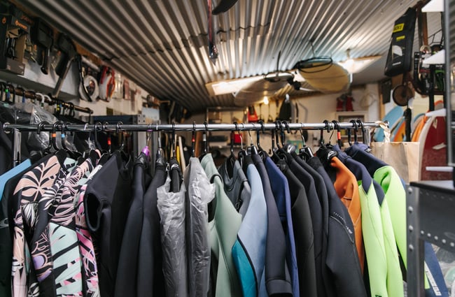 Rack of wetsuits Kaikōura Surf Company.