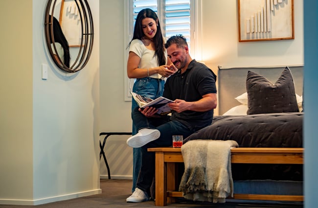 Couple in a bedroom in the accommodation suite in Kaitahi Lodge.