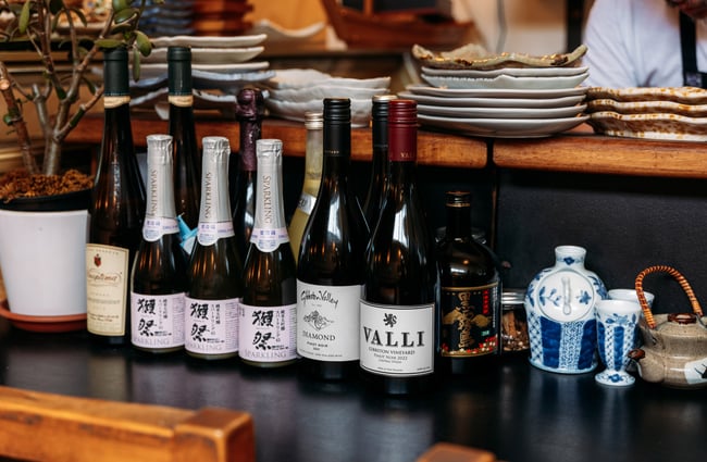 Bottles of Japanese wine on display on a table.