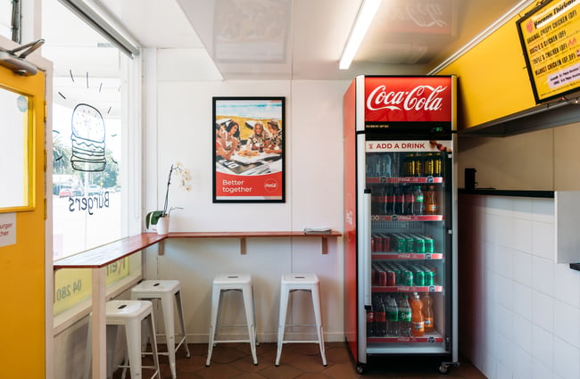 Tall bar seating inside a friend chicken shop.