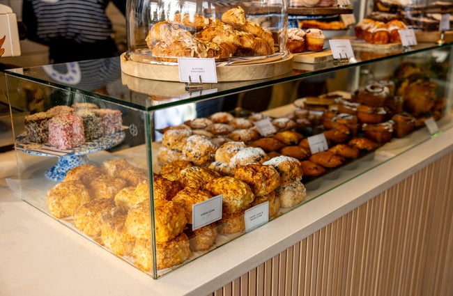 A close up of scones in a glass cabinet.