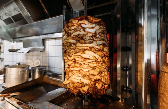 Doner kebab meat rotating on a vertical spit