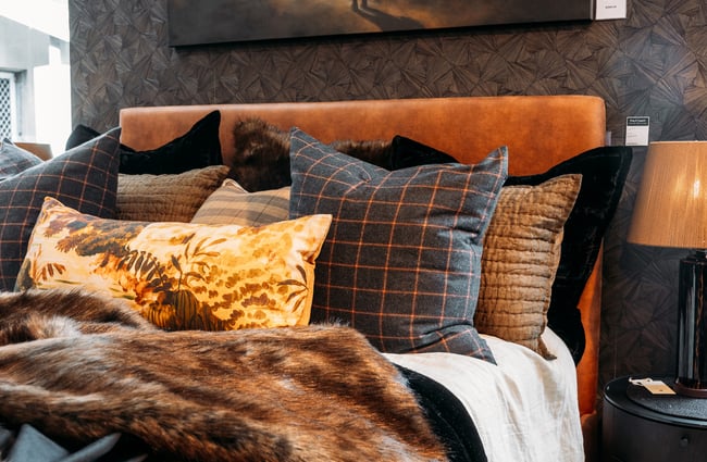 Cushions on a bed display at King & Teppett.