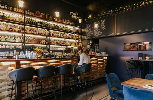 Woman sitting at the bar at Kismet.