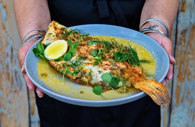 A whole plate of cooked fish.