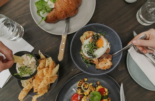 A flatlay of plates of food on a table.