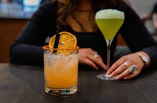 A close up of two cocktails on a table.