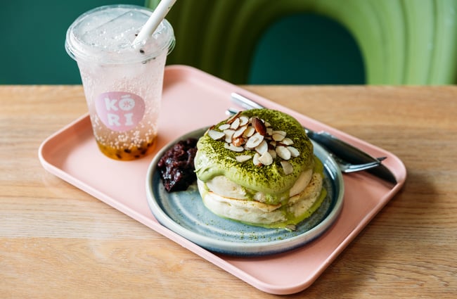 Matcha dessert and specialty drink on a pink tray at Kori Desserts.