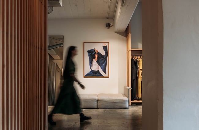 Blurred shot of a customer walking through the store at Kowtow.