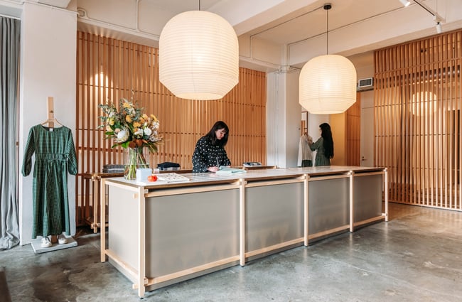 Shop assistants behind the counter at Kowtow.
