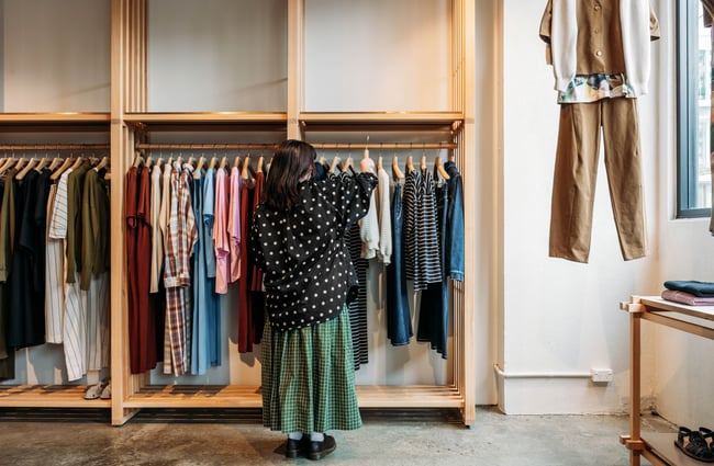 Shop assistant rehanging an item in Kowtow.