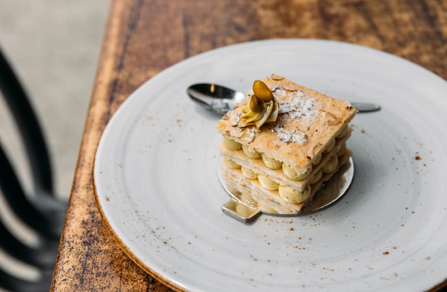 A close up of a layered pastry dessert on a plate.
