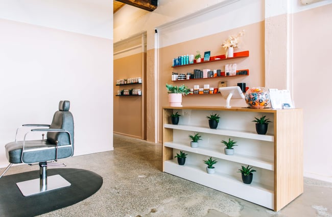 An empty seat inside Lab Brow bar next to the shop counter.