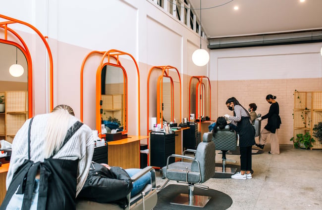 Staff at work on customers reclining in chairs.