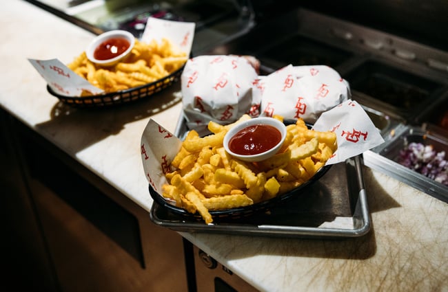 Baskets of hot chips and tomato sauce ramekins at Last Place Bar in Hamilton.