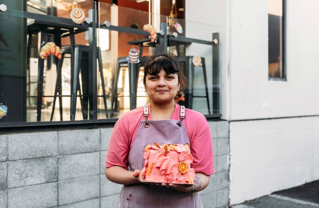 Owner Shuchi holding one of her amazing cakes.