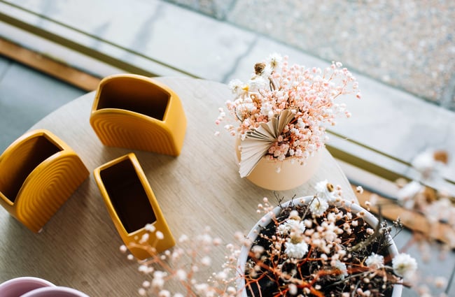 Vases and flowers on display in the window.