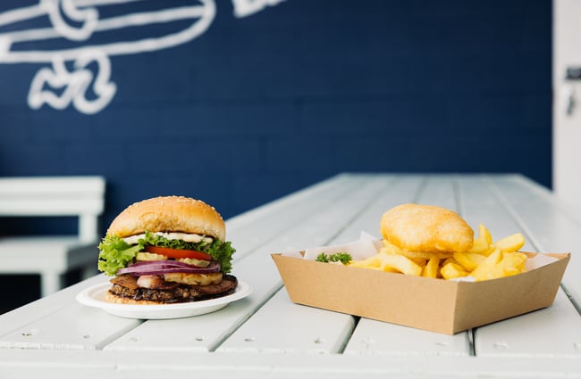 Burger and fish and chips on a table at Leigh Eats.