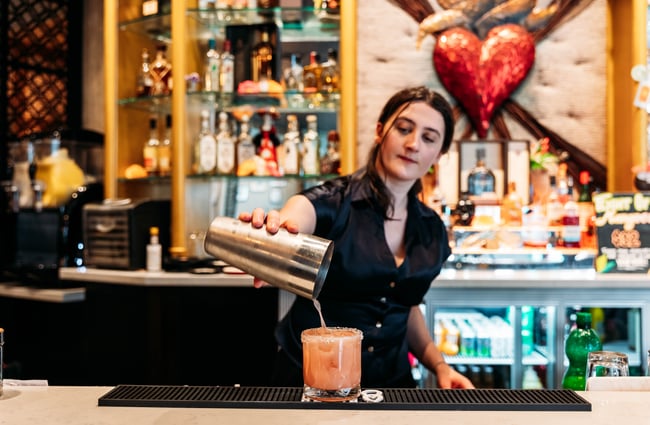 A bartender pouring a drink at Libre.