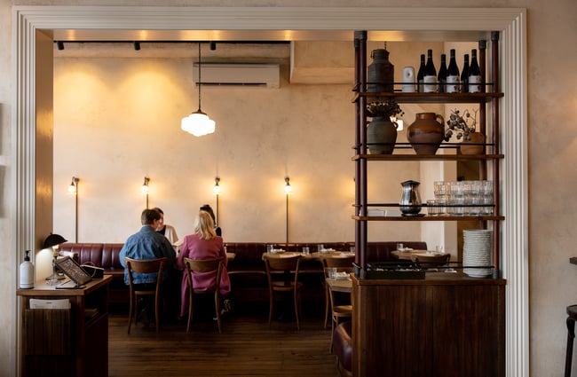 People dining at a table inside a restaurant.