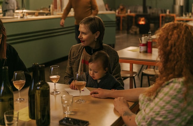 A child sitting on a woman's lap at a table.