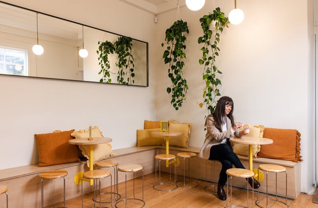 A woman sitting inside a cafe.