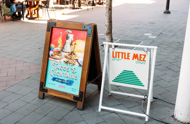Two street signs outside Little Mez.