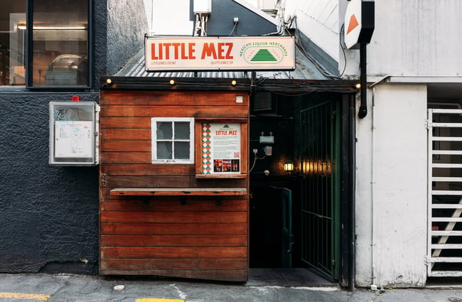A little wooden hut entrance to Little Mez Queenstown.
