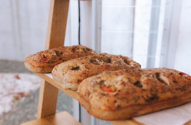 Three baked loaves on a shelf at Little Rosie, Auckland.