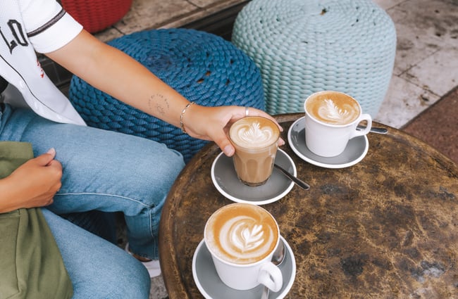 Person picking up a coffee up at Little Rosie, Auckland.