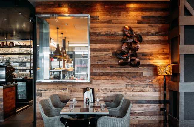 Table and chairs set up with a mirror in the background at Little Savanna.