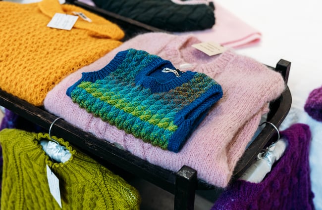 A close up of woollen clothes on display.
