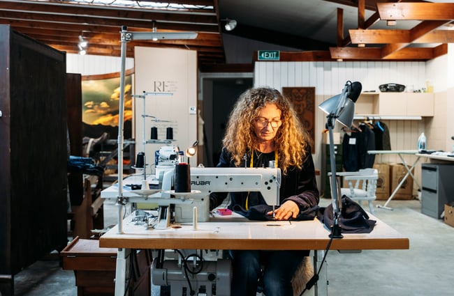 A woman at a sewing machine.