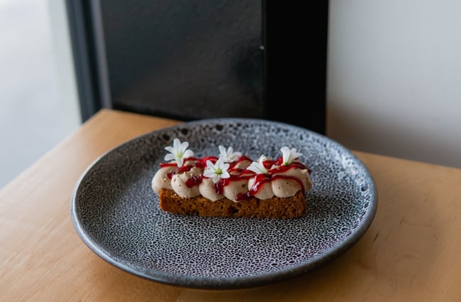 A close up of a long cake on a plate.