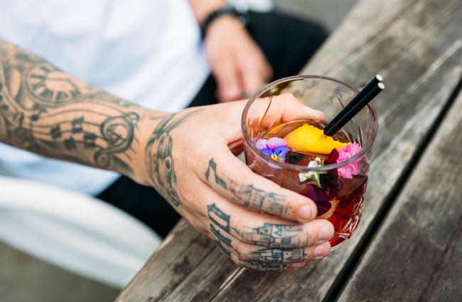 A hand holding a cocktail.
