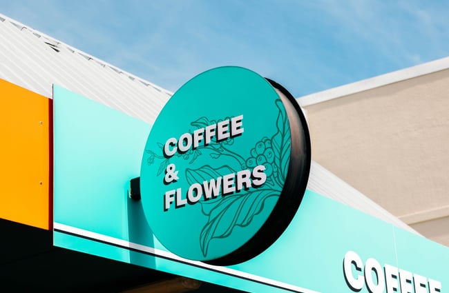 Coffee and flowers turquoise signage at Love Stomp.