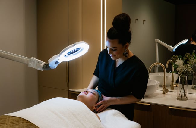 A customer receiving a facial in a day spa.