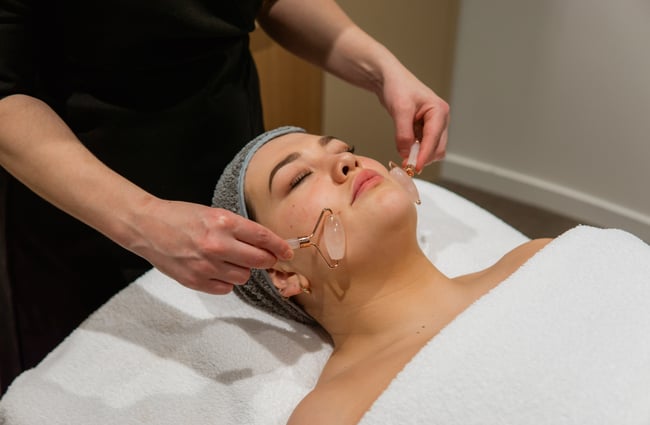 A close up of facial rollers on the skin.